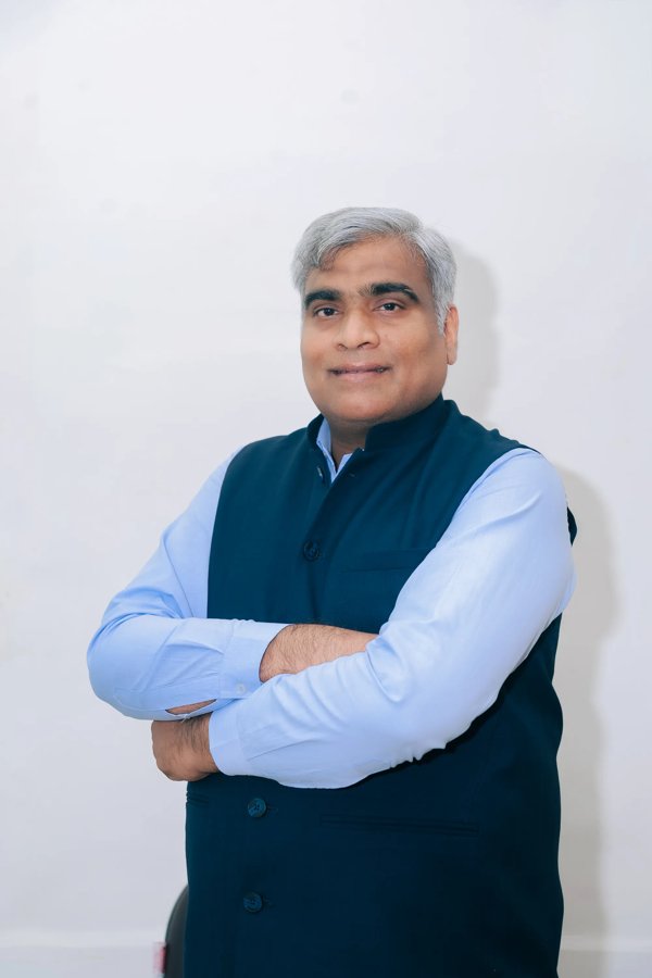 Dr. Naval Singh Jain, Director of the Pragya Group of Institutions, seated at his office desk